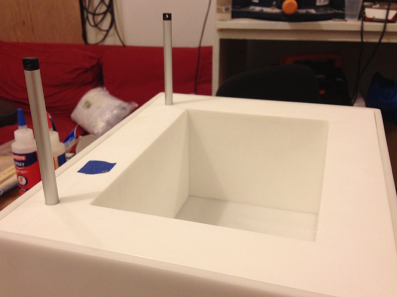 Tray, risers, and openings for the lifting mechanism.