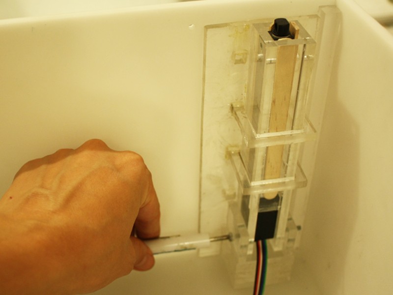 Clear actuator housing inside the enclosure.